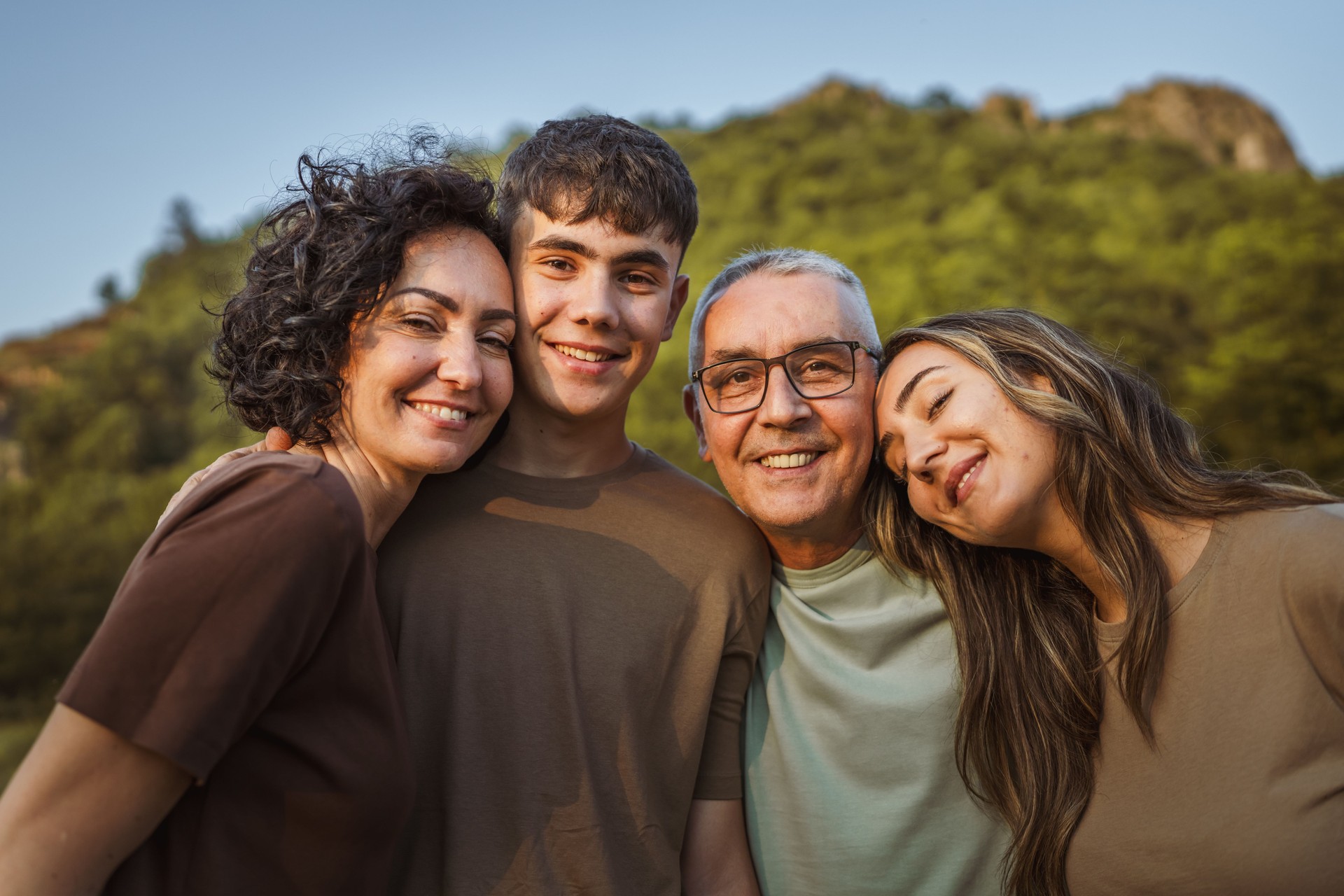Portrait of caucasian hugged family spend time together in nature