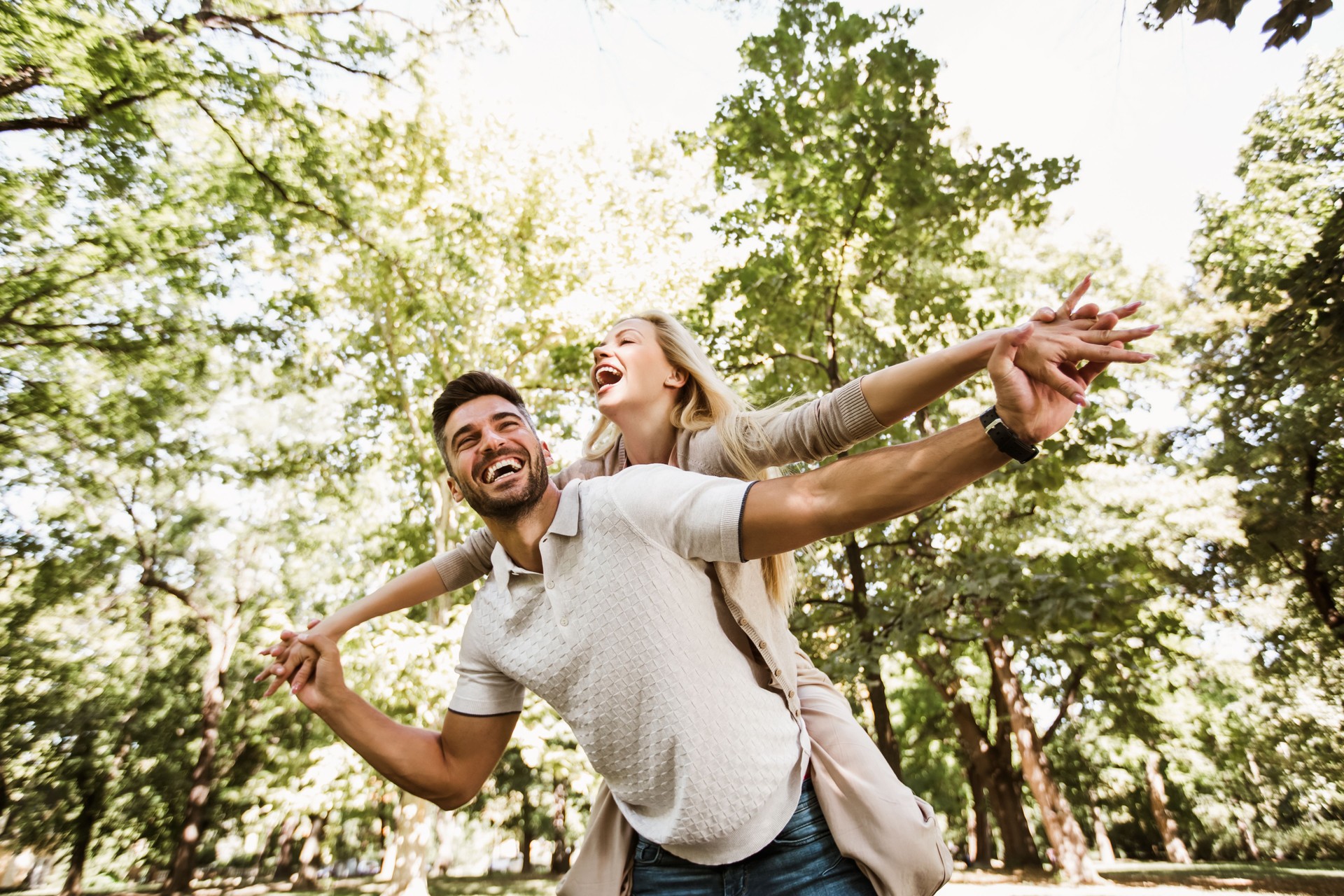 Portrait of romantic couple enjoying in park, having fun.
